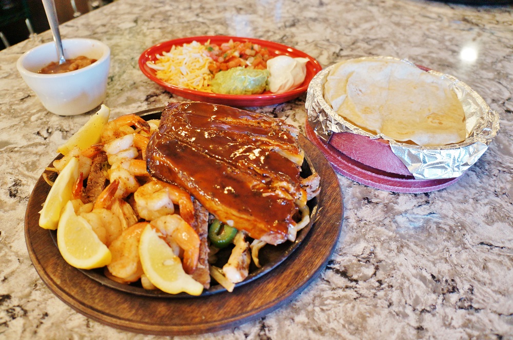 Trio fajitas meal with tortillas and sides